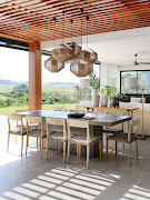 A cluster of jute lampshades create a dramatic statement above the patio dining table.