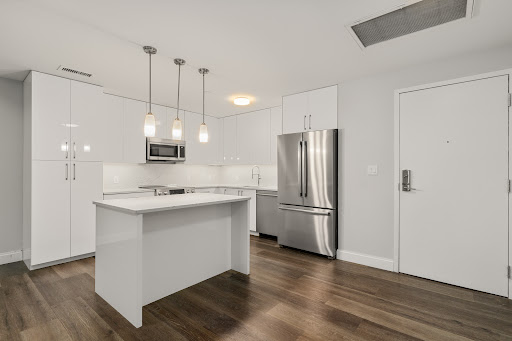 Modern kitchen with white island and stainless steel appliances - Buy this luxury apartment / penthouse in Boston, 3 bedrooms