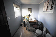 IT'S A SNIP: Dr Thabo Mashigo performs a circumcision at the Boipelo Clinic in Orange Farm, south of Johannesburg. He has more than 25000 such snips under his belt