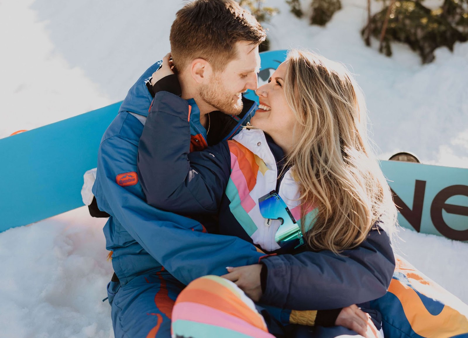 Couple posing for engagement photos in the snow