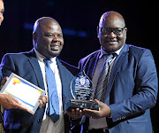 Premier  David Makhura, right,   poses with George Sono, the principal of Bokhoni Technical Schhol in  Randburg yesterday. 