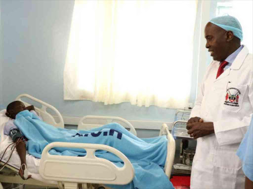 Kajiado Governor Joseph Lenku chats with a patient at Kajiado County Referral Hospital after commissioning five renal dialysis units, February 23, 2018. /KURGAT MARINDANY