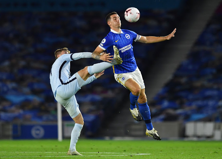 Brighton's Lewis Dunk in action with Chelsea's Timo Werner