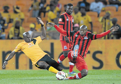 SLIDING TACKLE: Willard Katsande of Kaizer Chiefs and Mondli Cele of Maritzburg United tussle for the ball during their Absa Premiership match at FNB Stadium last night. Chiefs won 1-0. Picture: Gallo Images