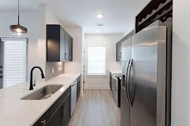 Galley style kitchen with wood finish flooring