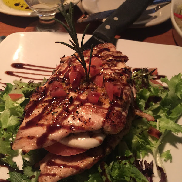 Chicken Abruzzi,  Char-broiled chicken breasts layered with portobello mushrooms, fresh mozzarella, over a field of greens with a balsamic reduction