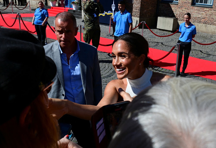 Meghan Markle talks to onlookers at the Invictus Games One Year To Go event.