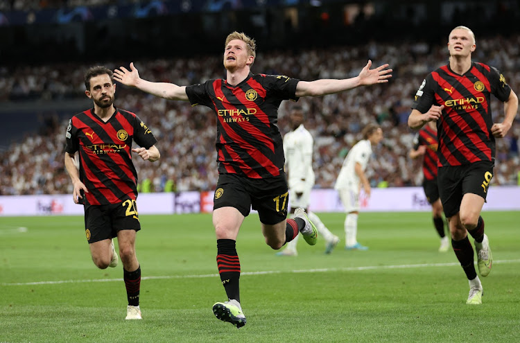 Kevin De Bruyne of Manchester City celebrates after scoring the team's equaliser during the Uefa Champions League semifinal, first leg against Real Madrid at Estadio Santiago Bernabeu on May 9, 2023 in Madrid