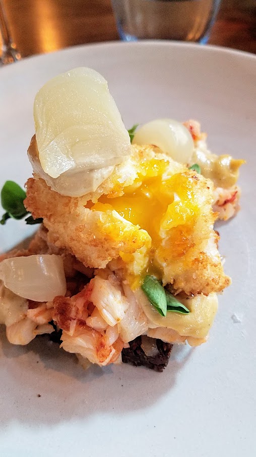 Restaurant Palaegade in Copenhagen offering traditional Danish smørrebrød and snaps - here is the specialty of the house - a Tartar of lobster with crispy fried egg and cress