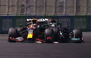 Max Verstappen and Lewis Hamilton collide during the F1 Grand Prix of Saudi Arabia at Jeddah Corniche Circuit on December 5 2021 in Jeddah, Saudi Arabia.