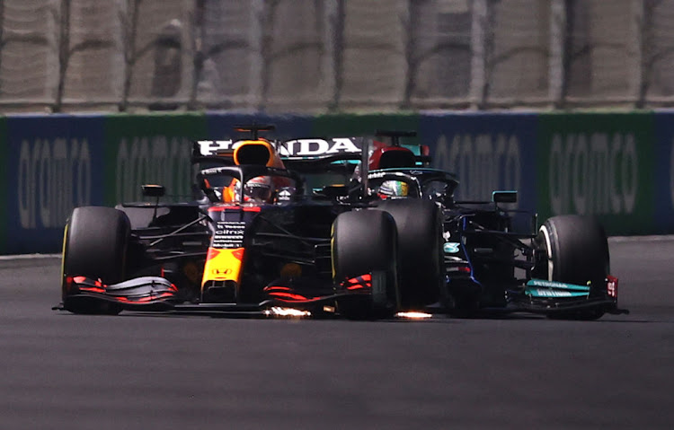 Max Verstappen and Lewis Hamilton collide during the F1 Grand Prix of Saudi Arabia at Jeddah Corniche Circuit on December 5 2021 in Jeddah, Saudi Arabia.