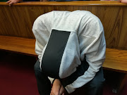 The man accused of raping a child in a Dros restaurant in Pretoria hangs his head in the dock on November 28, 2018.