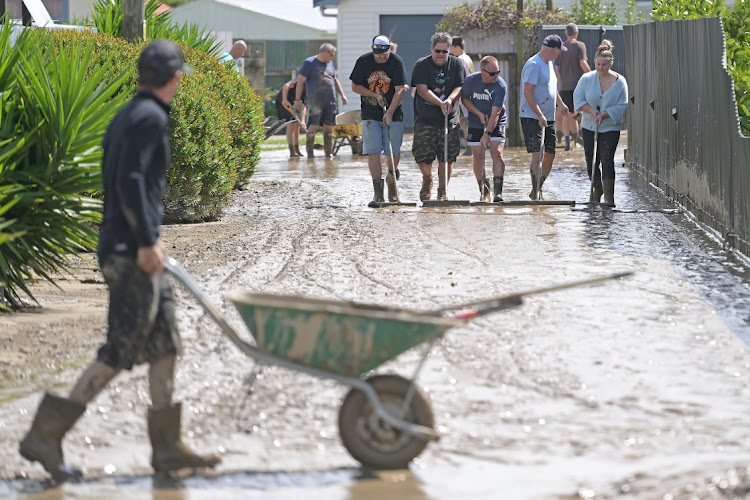 Residents in Taradale clean up following flood waters in Napier, New Zealand. Cyclone Gabrielle has caused widespread destruction across New Zealand's North Island. Picture: KERRY MARSHALL/GETTY IMAGES