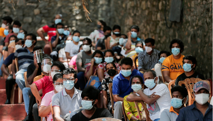 People wait to receive their doses of Sinopharm vaccine against the coronavirus disease in Colombo, Sri Lanka on August 20, 2021.