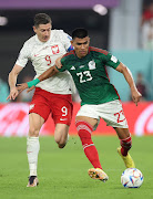 Mexico's Jesus Gallardo in action with Poland's Robert Lewandowski.