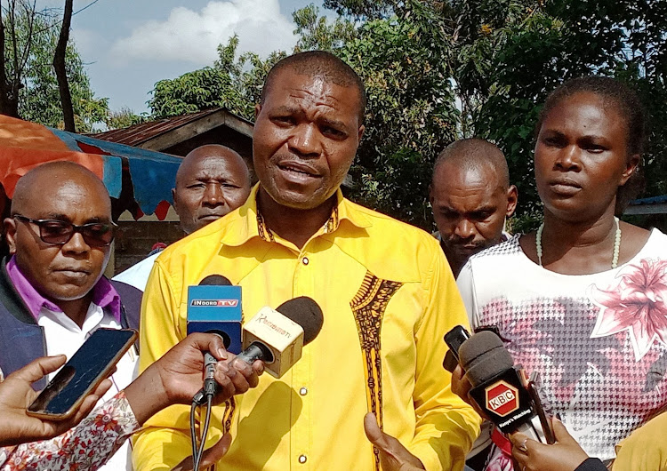 Gichugu MP Gichimu Githinji addressing the media during the distribution of the Uwezo fund cheques