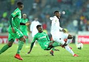 Augustine Mulenga of Orlando Pirates, who scored the equaliser is challenged by Kelvin Madzongwe of FC Platinum during their CAF Champions League match at Orlando Stadium on Friday night.  