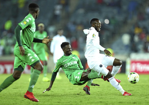 Augustine Mulenga of Orlando Pirates, who scored the equaliser is challenged by Kelvin Madzongwe of FC Platinum during their CAF Champions League match at Orlando Stadium on Friday night.