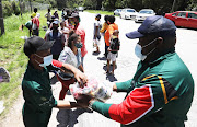 Residents from Wilderness Heights informal settlement receive aid from the Gift of the Givers.