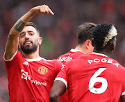 Bruno Fernandes celebrates with his Manchester United teammates after scoring a goal in a 5-1 thrashing of old rivals Leeds United at Old Trafford on August 14 2021. 