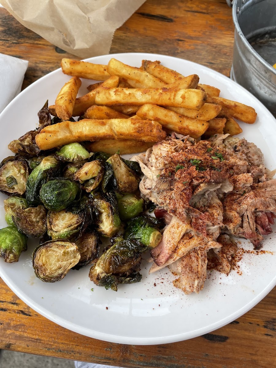 Pulled pork with seasoned fries and crispy Brussels sprouts.