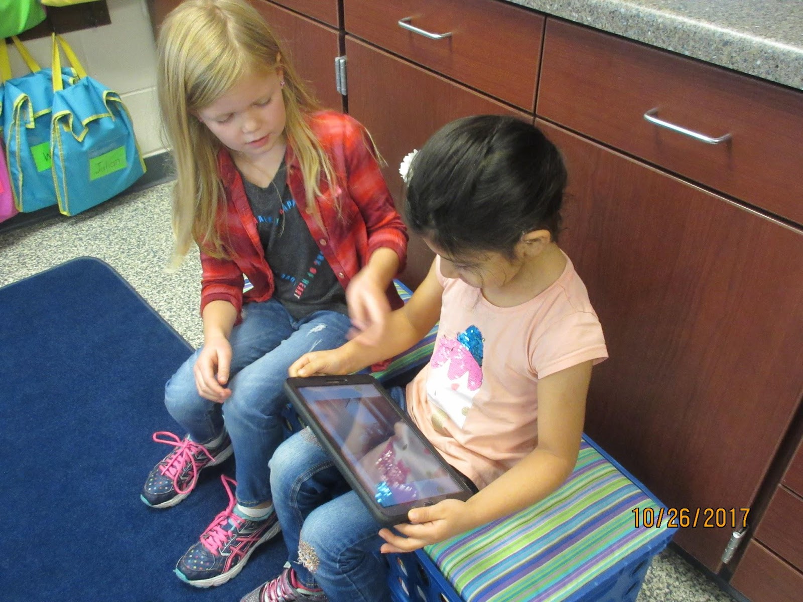 Students reading together from tablet