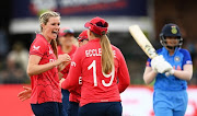 Lauren Bell of England celebrates the wicket of Shafali Verma of India with team mates Sophie Ecclestone and Heather Knight during the ICC Women's T20 World Cup group B match between England and India at St George's Park on February 18, 2023 in Gqeberha, South Africa.