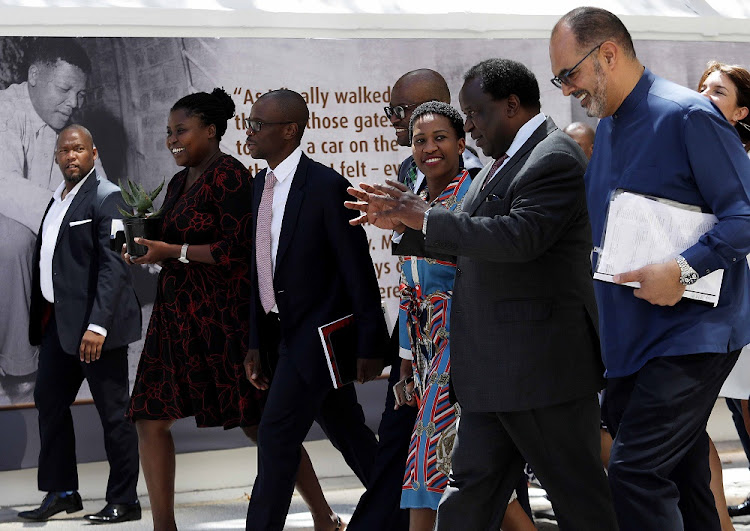 Finance minister Tito Mboweni and his team walk past an image of SA's late statesman Nelson Mandela during the 2020 Budget presentation to parliament on February 26 2020.