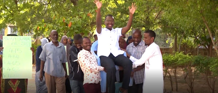 Faud Abdirizak Mohamed of Mnara Junior Academy is lifted shoulder high by teachers and parents on Tuesday, March 29.