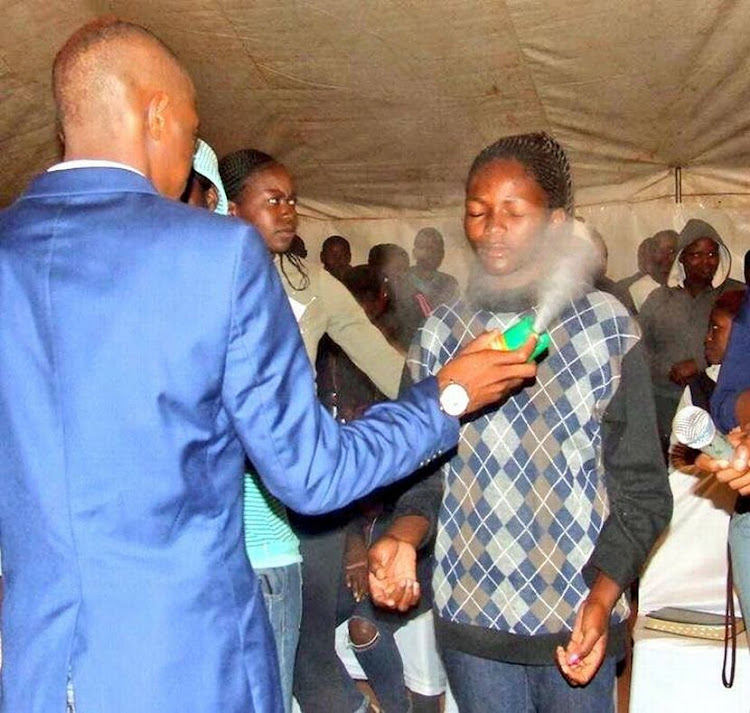 A church congregant sprayed with Doom