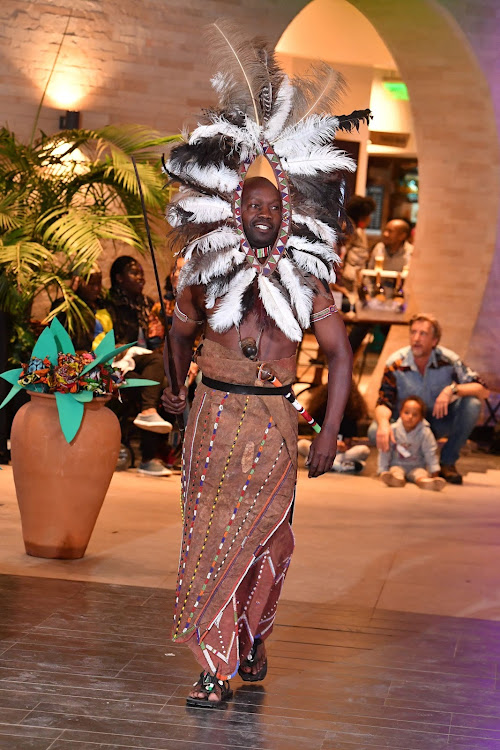 A participant displays an African headgear