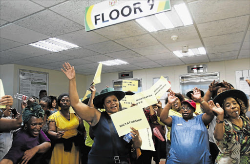 GOT A BEEF: Department of rural development and agrarian reform workers protest at their main office, the Dukumbana building, in Bhisho Picture: MICHAEL PINYANA