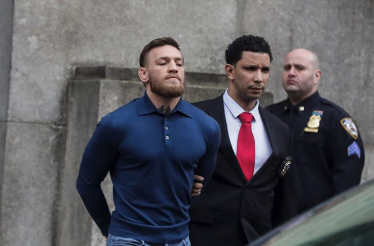 MMA fighter Conor McGregor walks out of the 78th police precinct after charges were laid against him following a late night melee in the Brooklyn borough of New York City, April 6, 2018.