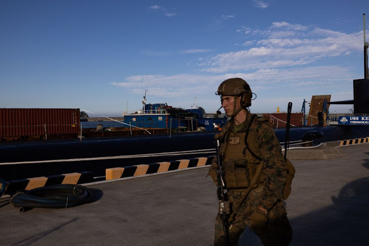 A member of the US Navy guards the USS Kentucky ballistic missile submarine in Busan, South Korea, on Wednesday, July 19, 2023.