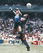 Diego Maradona uses his hand to score Argentina's first goal past England goalkeeper Peter Shilton during the 1986 World Cup quarterfinal at the Aztec Stadium in Mexico City.