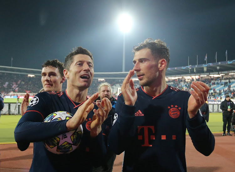 Bayern Munich's Robert Lewandowski and Leon Goretzka applaud fans after the match