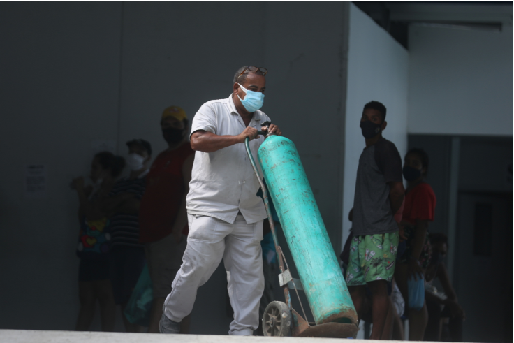 A worker takes an oxygen tank inside at a public hospital, during the coronavirus disease pandemic, in Duque de Caxias city in Rio de Janeiro state, Brazil on March 30 2021.