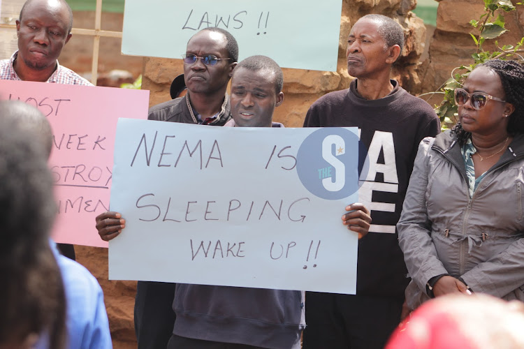 Lavington residents carrying placards in opposition to construction of a 13-storey building in the area