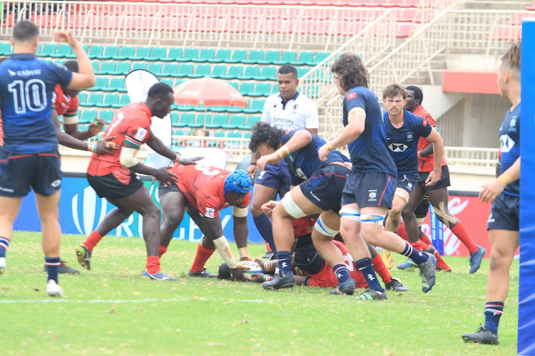 Chipu's Mike Oduor picks the ball to score his second try for Chipu against Hong Kong during the World Rugby Under-20 trophy at the Nyayo National Stadium on July 25, 2023