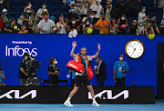 Stefanos Tsitsipas acknowledges fans as he walks off the court after winning his quarter final match against Italy's Jannik Sinner.