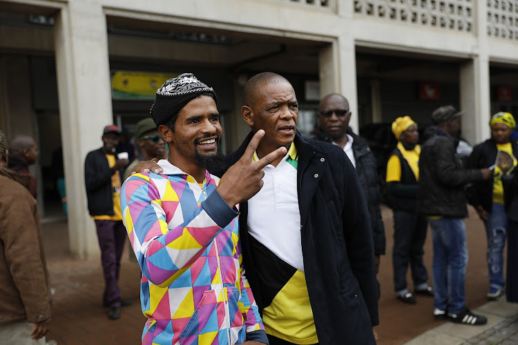 Ace Magashule takes a picture with a member of the community in Kliptown.