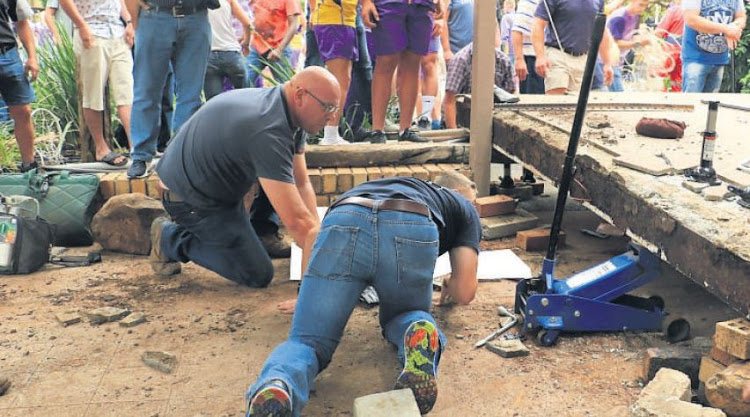 The community used whatever implement they could to, including a car jack to lift the concrete slab that trapped schoolchildren at Hoërskool Driehoek in Vanderbijlpark last Friday.