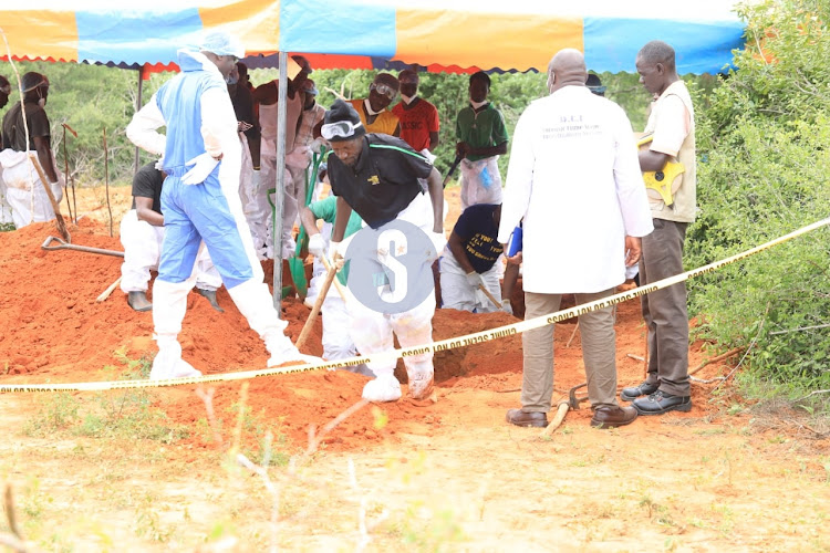 Detectives exhuming bodies in Shakahola forest on June 12, 2023.