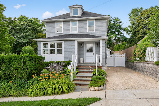 Gray house with flower garden in this luxury house for rent in Locust Valley ($5,500)