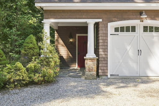 Red entry door and white garage door in this luxury house for rent in Ridgefield ($2,100)