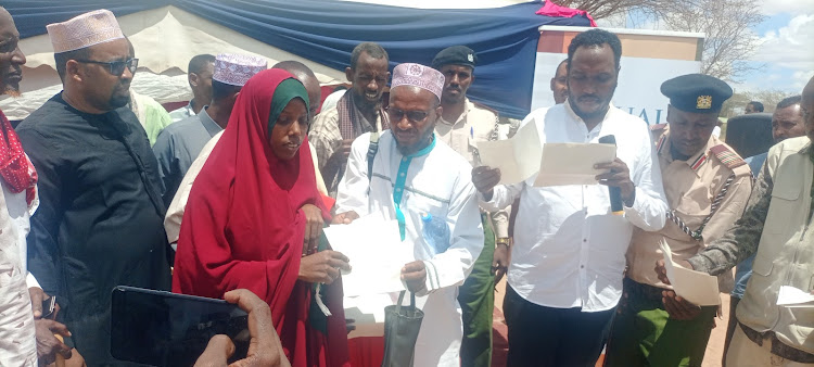 Fafi MP Salah Yakub leads the distribution of birth certificates to children in Warbale, Nanigi ward on Saturday