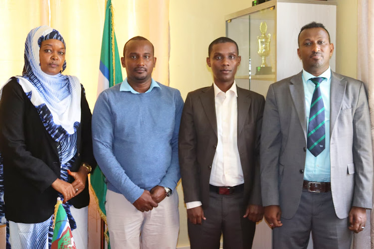 New chief officer medical services Dr Alamin Adan and public health services Omar Boko with CECM Health Grace Galmo and outgoing chief officer Mr Tache Elema at department office