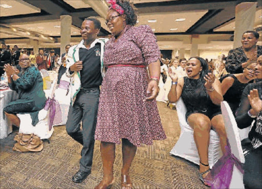 KING COOL: Top achiever from the King William’s Town district Vuyanathi Mpande from Ndabankulu Senior Secondary School, makes his way to the stage flanked by a family member Picture: MARK ANDREWS