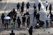 Anti-government protesters gather bricks to set up barricades during a demonstration at the Central District in Hong Kong, China, November 13, 2019. 