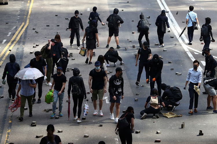 Anti-government protesters gather bricks to set up barricades during a demonstration at the Central District in Hong Kong, China, November 13, 2019.